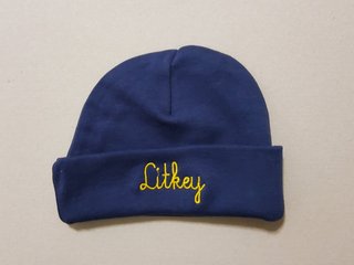 Eine blaue Baby-Mütze mit dem Schriftzug "Litkey"